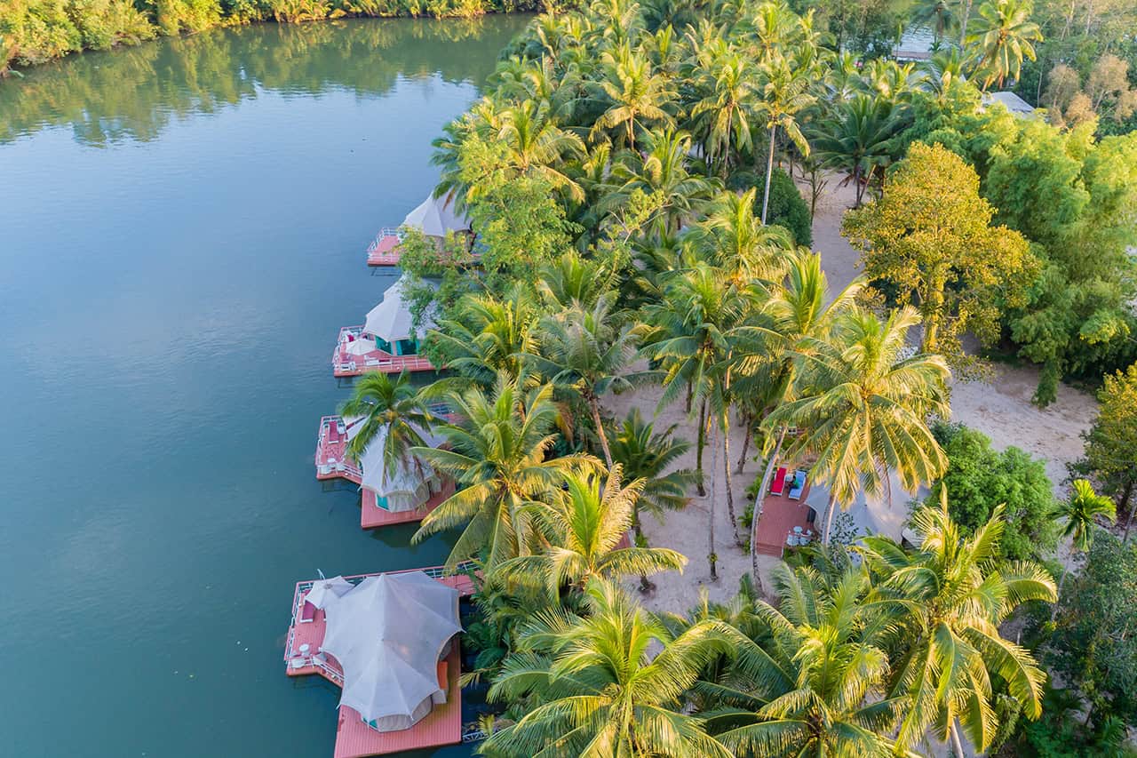 Aerial view of Canvas & Orchids Retreat glamping tents and river landscape in Koh Kong, Cambodia