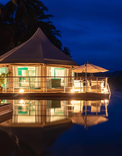 Evening riverside glamping and accommodation at Canvas & Orchids Retreat on the Tatai River in Koh Kong, Cambodia